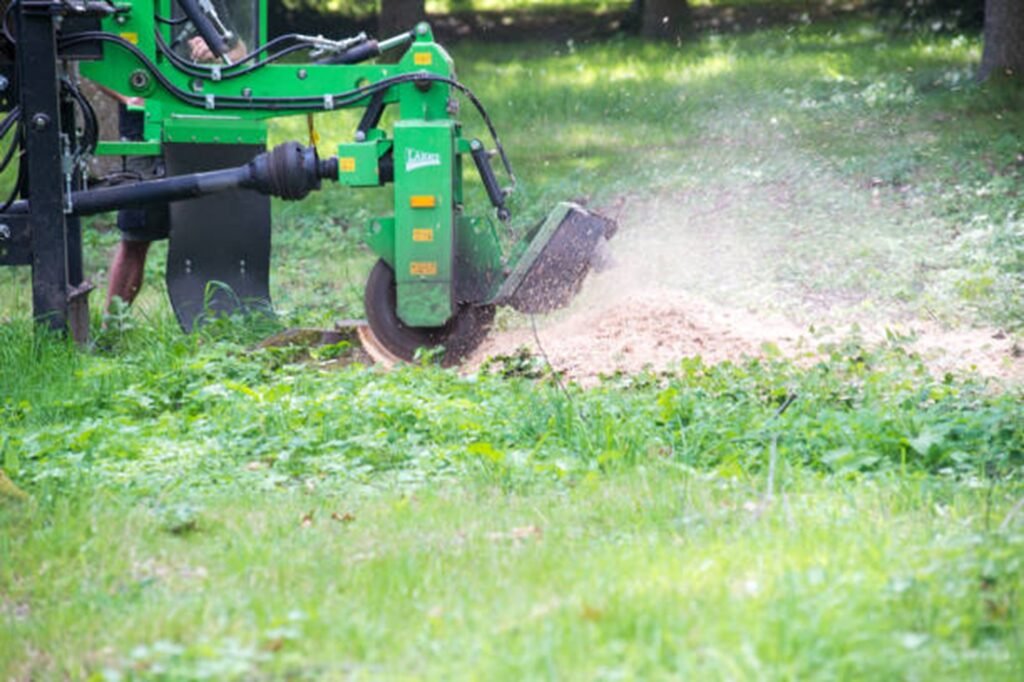 Stump grinding equipment removing a tree stump from a residential yard in Fairlawn, OH